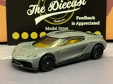 1:64 diecast sports car, light gray with dark wheels, front 3/4 view