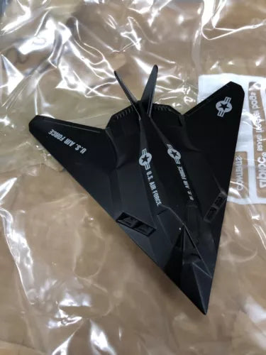Black stealth aircraft diecast model plane with twin tail fins and wing tips