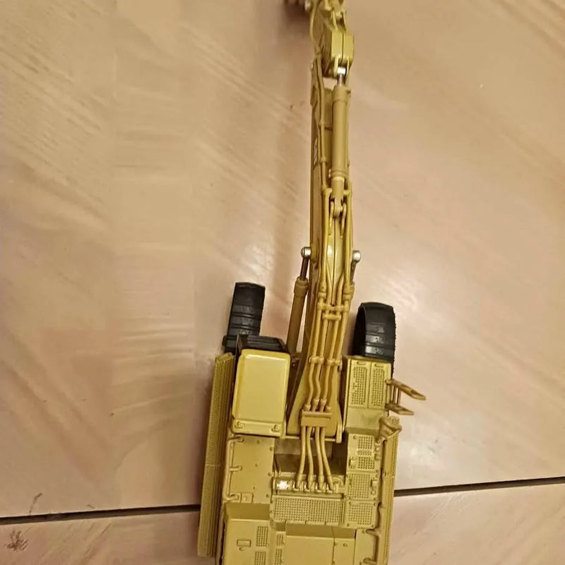Diecast metal collectible machine model in gold yellow with detailed pipes