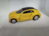 Yellow diecast pullback car with black roof and hood, chrome wheels