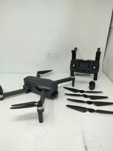 Foldable black quadcopter drone with propellers and remote controller, ready to fly