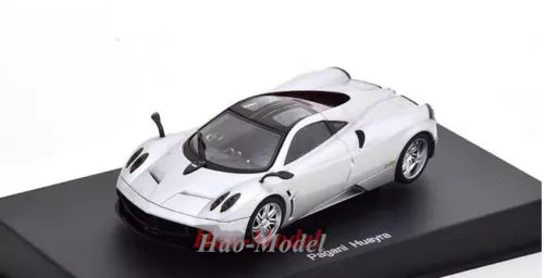Diecast model car, silver sports car in front three-quarter view, detailed wheels and decals