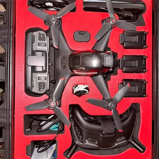 DJI racing drone with four propellers and front camera module, in a case