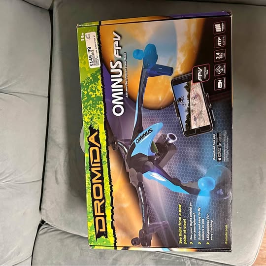 Boxed blue and dark drone toy with controller, retail packaging