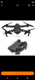 Foldable quadcopter drone with four propellers, dark gray body