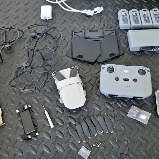 DJI Mini 2 controller with accessory parts, including prop guard and battery