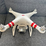 White quadcopter drone with red stripes and front camera module