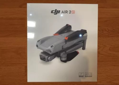 DJI Air 2S drone, dark gray with orange accents, front camera gimbal