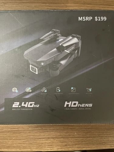 Gray 4K quadcopter drone with foldable arms, shown on product box top