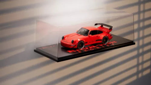 Tarmac diecast display shelf with red diecast car on black base