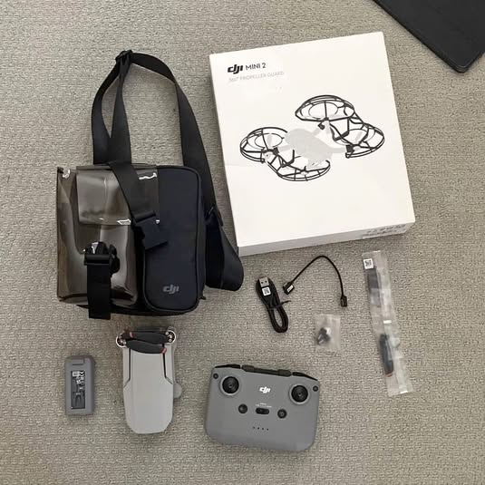 DJI Mini 2 drone kit with controller, protective case, batteries, and instruction booklet