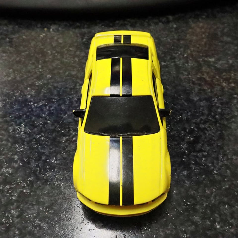 Yellow diecast toy car with black racing stripes and black windows
