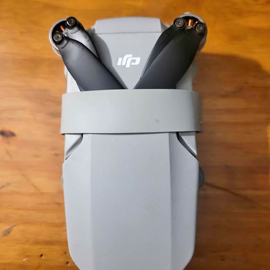 DJI Mini 2 drone with arms folded and dark gray prop guards