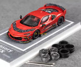 Red racing diecast model car with detailed body and black wheels, 1:64 scale