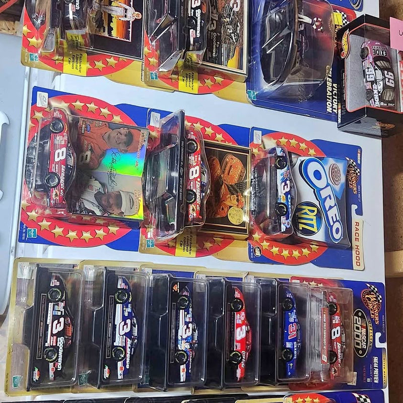 Assorted 1/43 NASCAR diecast cars in blister packs