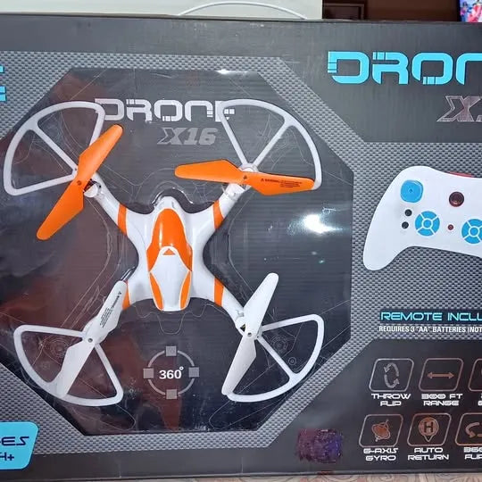 Orange and white quadcopter drone with four propellers, in retail packaging