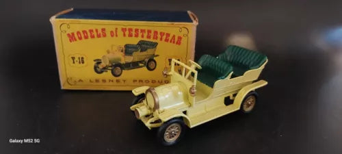 Vintage diecast Spyker automobile with open top and cream body, on display