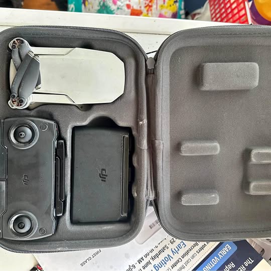 Grey drone case interior with controller and storage compartments