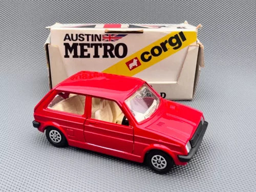 Red Austin Metro diecast model car toy, front side view with box