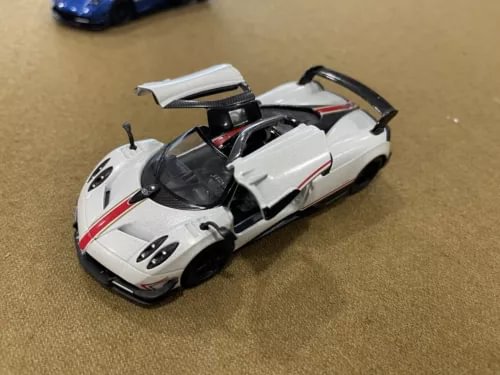 White and red 1:38 diecast model sports car with open cockpit and black detailing