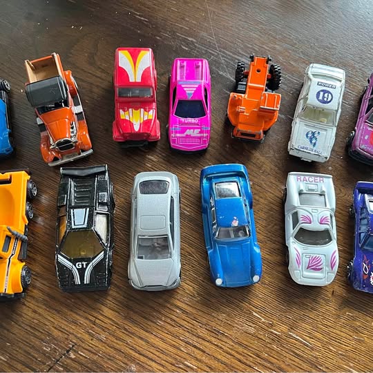 Mixed diecast car lot with multiple unbranded vehicles in assorted colors, top view