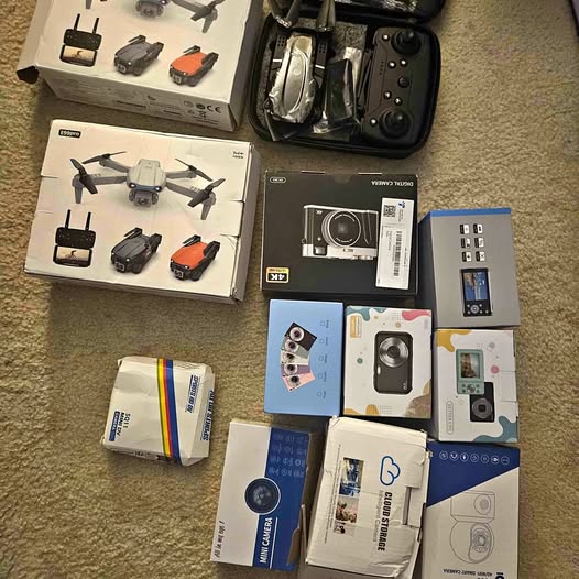 Drone camera security monitor kit with drone, controller, and camera accessories in boxes