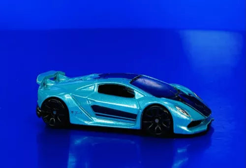 Blue diecast sports car model with black wheels and hood scoop