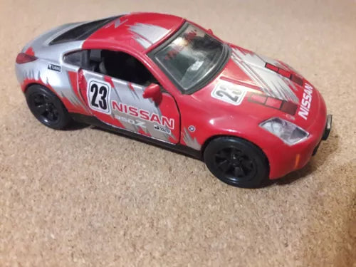 Red and white diecast sports car model with NISSAN decals, black wheels