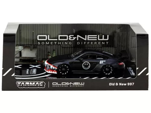 Matt black diecast model car in display box, front three-quarter view