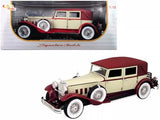 Vintage cream and red diecast model car, four-door sedan with whitewall tires