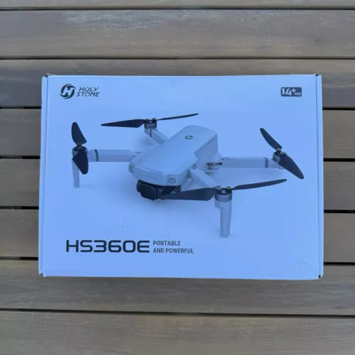 White quadcopter drone illustration on a product box, four propellers