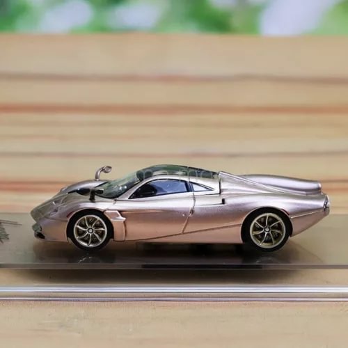 Die-cast sports car model in silver with black roof and detailed wheels