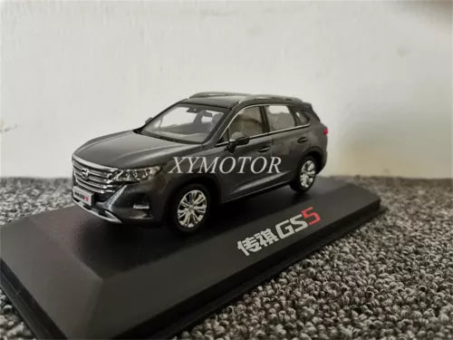 Gray diecast MPV model car on display base, front three-quarter view