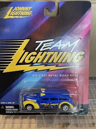Blue and yellow Team Lightning die-cast ambulance model in blister packaging