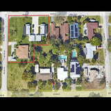 Aerial drone view of residential property with houses, trees, and backyard pool