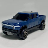 Blue diecast EV pickup truck model, 1:64 scale, front three-quarter view