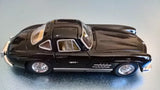 Black gullwing diecast Mercedes car model, front side view with open doors and wheels
