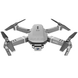 Gray foldable mini quadcopter drone with 4K camera and four propellers