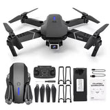 Grey quadcopter drone with HD camera and foldable propellers, shown with accessories