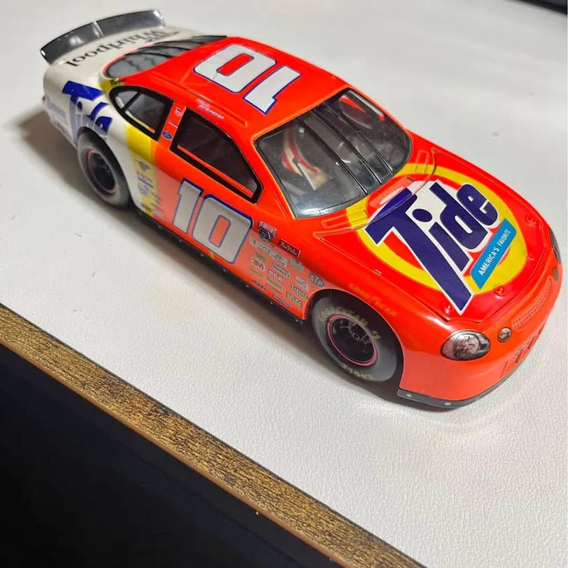 Red NASCAR diecast race car with #10 on hood, blue sponsor decals, front 3/4 view
