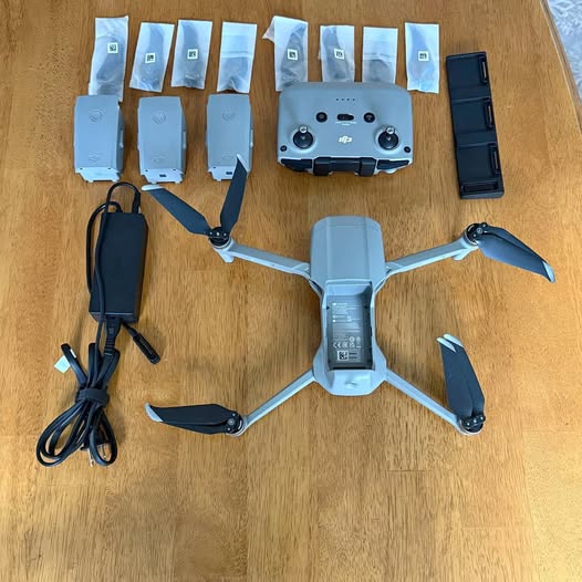 Quadcopter drone with four propellers and accessory battery packs