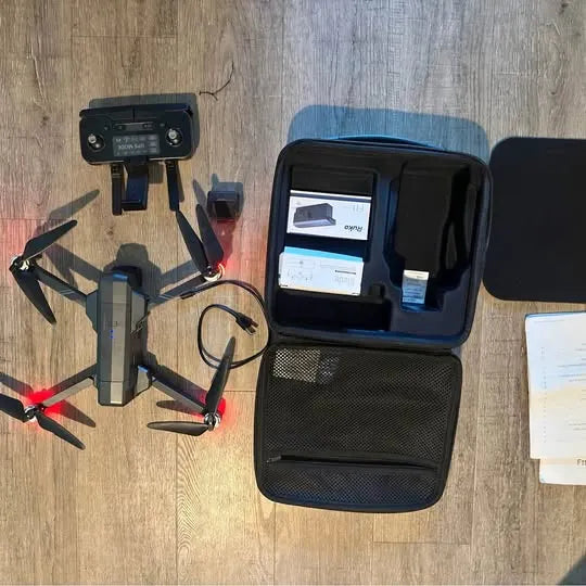 Drone kit with open carrying case and controller, showing screen and accessories