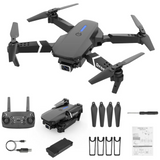 Black quadcopter drone with camera, propellers, remote controller, battery, spare parts and manual
