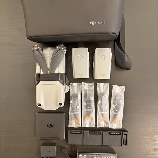 DJI Air 2S drone kit with white drone body, propellers, batteries, and accessories