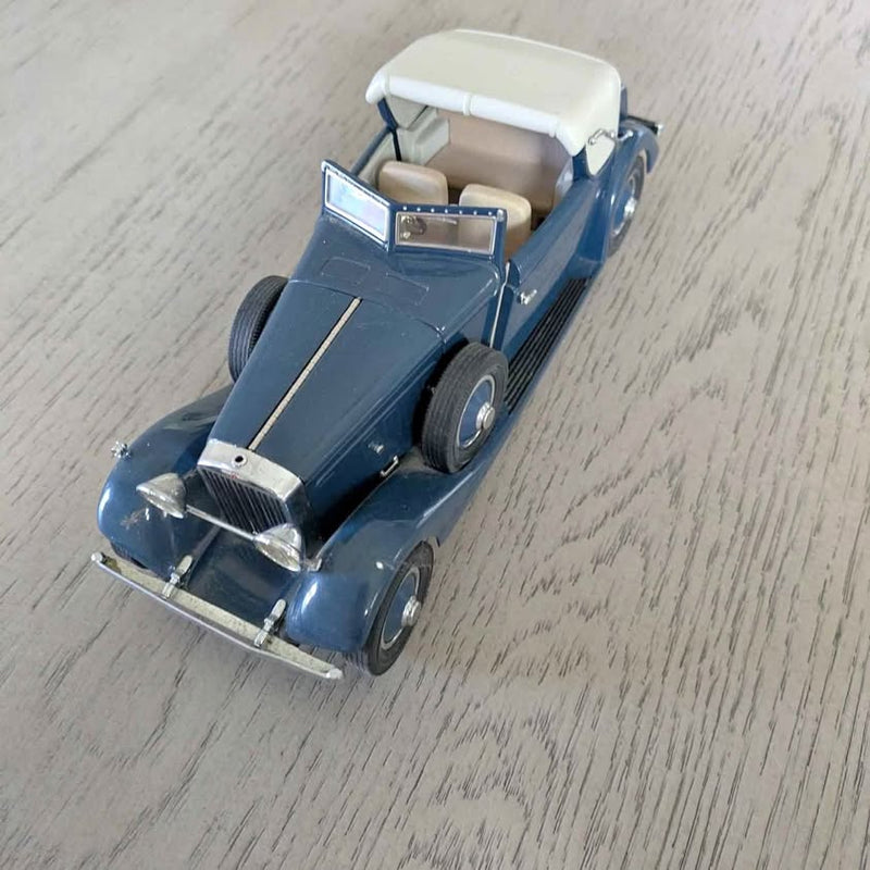 Blue vintage open-top car diecast model with white seats and hood ornament
