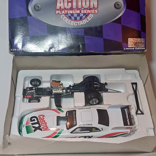 1:24 scale diecast funny car model in black, white, and red box packaging
