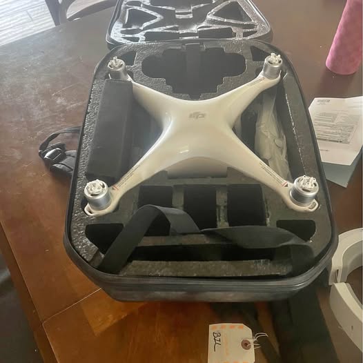 White quadcopter drone in hard case with foam cutouts
