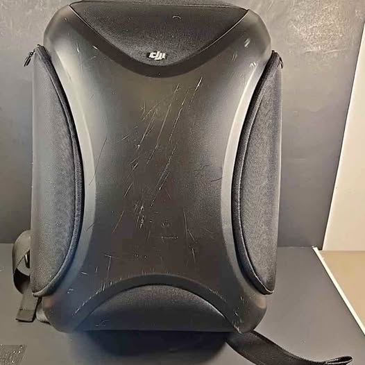 DJI multifunctional backpack, dark gray shell with front logo and padded side panels