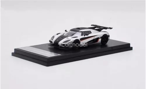 Silver diecast car model toy on black display base, front three-quarter view