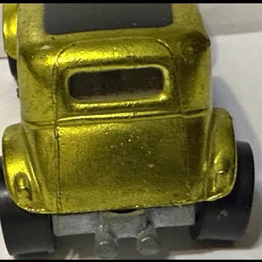 Metallic green diecast car front with grille and headlights